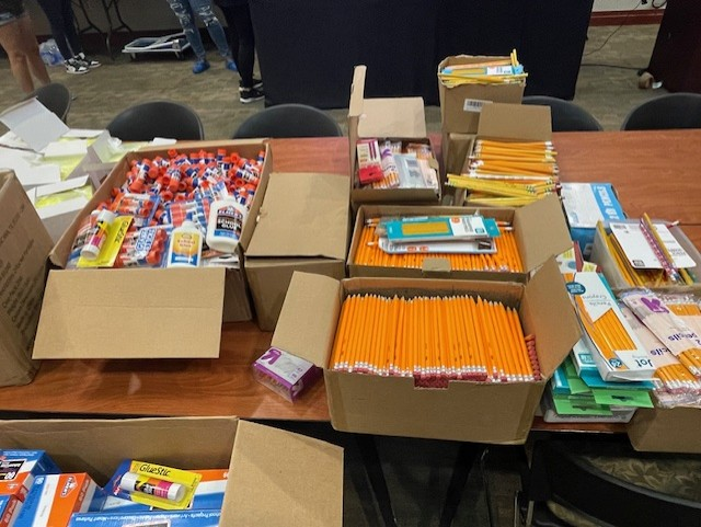 school supplies including large number ofpencils on a table